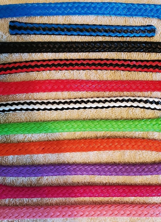 Colorful braided ropes on beige background