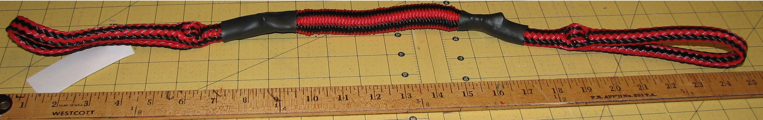 Measuring tape beside braided rope