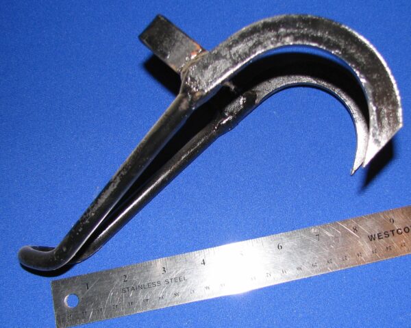 Metal hook with ruler on blue background