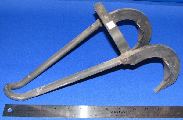 Curved metal tool beside measuring ruler