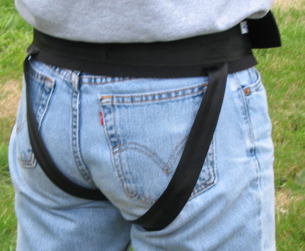 Person wearing jeans and black straps