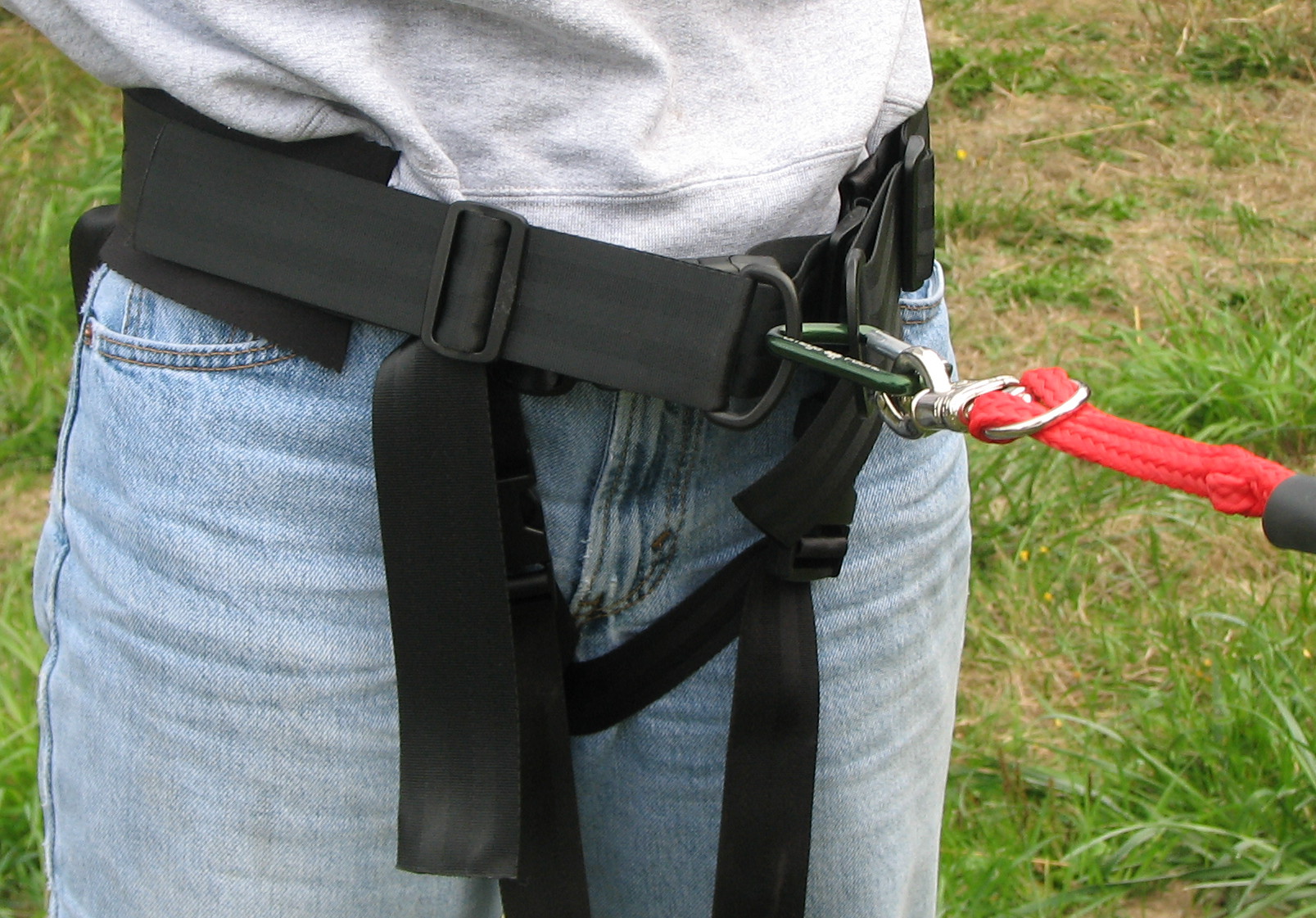 Person wearing a safety harness outdoors