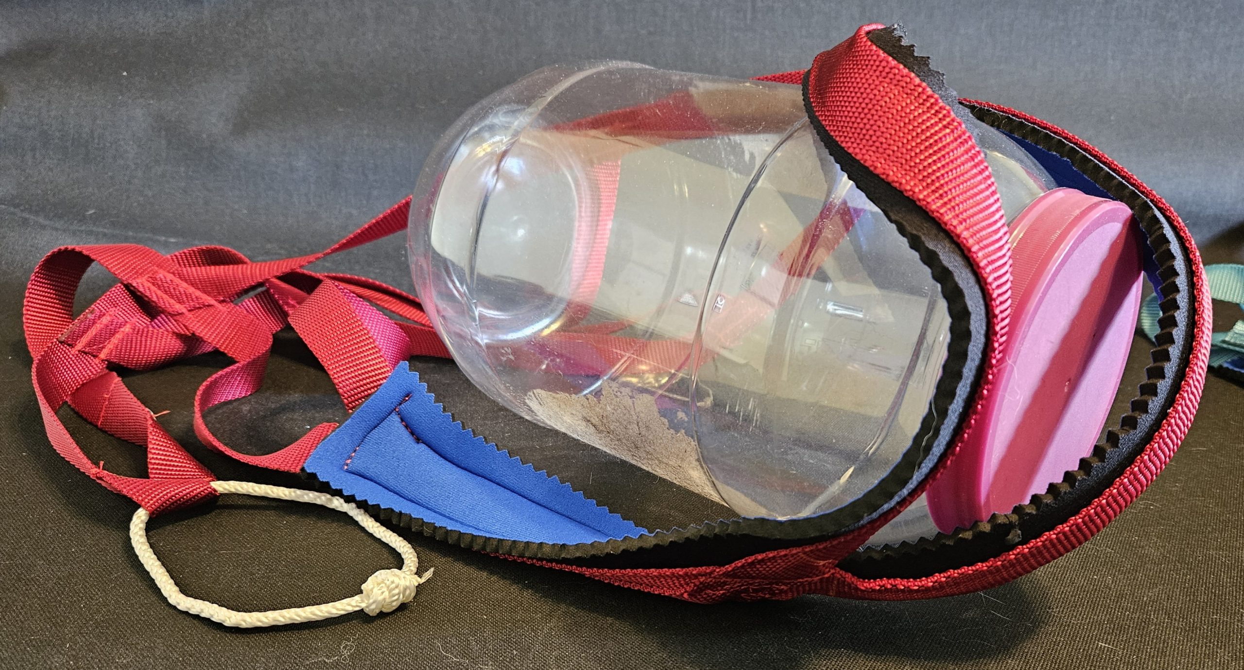 Plastic bottle in red strap holder