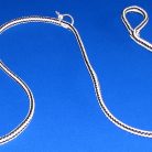 Jewelry piece displayed on blue surface